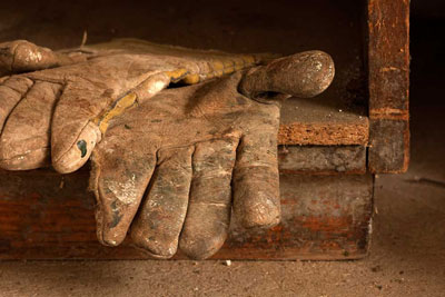 Leather contractor's work gloves on a table.