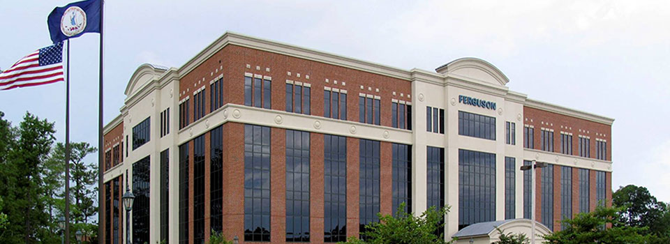 Ferguson executives stand on the lawn in front of the main headquarters.