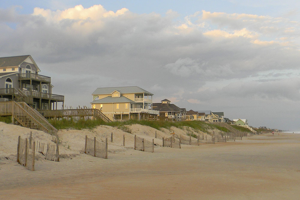 Outer Banks NC beach houses and sand dunes.